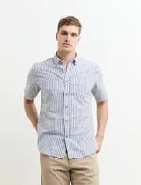 Camisa de manga corta a rayas verticales celestes y blancas, con cuello abotonado y corte clásico.