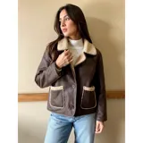 Campera gamulán de ecocuero marrón con forro y detalles de corderito en cuello, solapas y bolsillos. Cuenta con cierre frontal de botones y dos bolsillos aplicados.