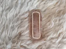 Broche para pelo artesanal de cuero con bordados en tiento fino.