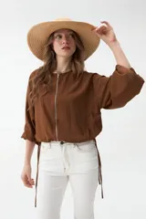 Campera negra corta con cierre frontal y mangas anchas.