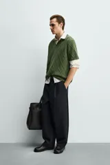 Polo regular fit verde de punto de algodón, con cuello solapa, abertura frontal y diseño de calados geométricos en rombos.