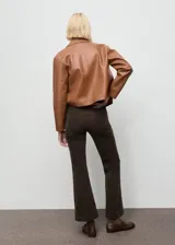 Pantalón de pana estilo flare con tiro medio, cierre de botón y cremallera, trabillas para cinturón y diseño de cinco bolsillos.