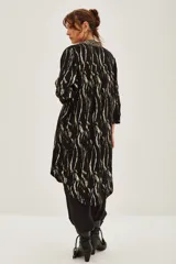 Kimono largo de jacquard con diseño de cebra y destellos de lurex. Presenta bordes con detalle de guarda tejida, mangas tres cuartos y forro interior.