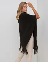 Poncho tejido negro con textura, cuello alto de velour negro y terminación con flecos largos en el ruedo.