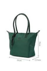 Bolso tipo tote negro de tela impermeable, con doble asa de mano y cierre superior con cremallera. Incluye un colgante decorativo de cordón blanco y negro.