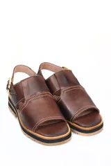 Sandalia de cuero marrón oscuro, estilo pescador cerrado en la punta y abierto en el talón con tira ajustable y hebilla dorada. Presenta costuras blancas visibles y suela de goma gruesa con plataforma y taco bajo.