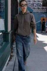 Sudadera de manga larga con capucha ajustable mediante cordones, bolsillo frontal tipo canguro y puños y ruedo en tejido rib.