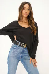 Buzo negro de mangas largas con escote en V y corte holgado.