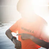 Remera deportiva de manga corta color naranja, con logo de la marca estampado en el frente. Confeccionada en tejido técnico elástico de secado rápido, ideal para actividades al aire libre.