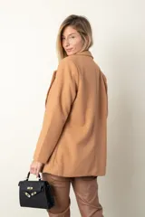 Blazer color camel de paño, corte recto, con solapas y cierre frontal con un botón.