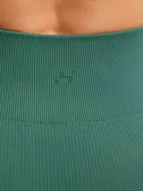 Calza deportiva de tiro alto con textura acanalada, diseñada para brindar ajuste y soporte durante la actividad física.