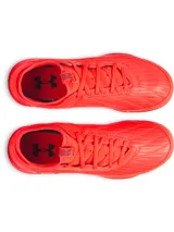 Championes de fútbol sala Under Armour Magnetico Select 4, color naranja vibrante con suela de goma color caramelo. Presenta un diseño de ajuste tipo calcetín con cuello textil, parte superior de piel sintética suave y logo de la marca con detalles gráficos en el lateral.