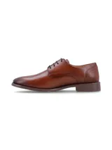 Zapato de vestir tipo derby para hombre, confeccionado en cuero color bronce con acabado liso. Presenta cierre con cordones, costuras reforzadas en el lateral y suela de goma con tracción.