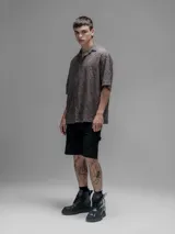 Camisa clásica de manga corta, color chocolate con efecto desgaste, confeccionada en algodón bordado (broderie) con diseño floral calado. Presenta cuello abierto y calce oversize.