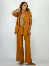 Pantalón de vestir color ocre metalizado, de corte palazzo y tiro alto. Confeccionado en lino y viscosa.