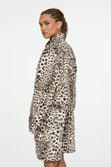 Chaqueta de denim de corte recto, con cuello camisero, cierre frontal con botones y bolsillos con solapa en el pecho, con estampado animal print.