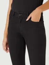 Pantalón de jean negro de corte skinny y cintura media, con cierre frontal y bolsillos laterales.