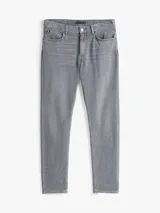Pantalón jean slim gris con efecto desteñido y usado en la cintura. Confeccionado en tejido denim elástico de algodón. Cierre de cremallera con botón y diseño de cinco bolsillos. Incluye logo de Tommy Hilfiger bordado en el bolsillo trasero.