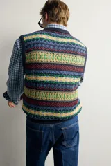 Chaleco regular fit de punto tejido en hilatura de lino, con diseño de patrones geométricos multicolor en tonos azul, verde, amarillo y rojo. Presenta cuello en V, manga sisa y acabados en rib. Colección especial Aaron Levine x Zara.