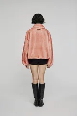 Campera corta de pelo sintético en color beige, con diseño de volumen amplio, cuello clásico, cierre frontal con cremallera y bolsillos laterales integrados.