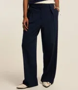 Pantalón de vestir azul marino, de corte recto, con pinzas delanteras, bolsillos laterales y traseros. Se ajusta a la cintura con cierre invisible y trabillas para cinturón.