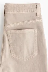 Jean tobillero de corte mom fit con cintura de tiro alto y diseño de cinco bolsillos en denim beige.