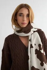 Bufanda rectangular de tejido suave con estampado de manchas tipo animal print en color marrón y crema.
