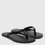 Sandalias de tipo chancleta color negro, con diseño minimalista, tiras finas y suela plana.