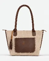 Cartera grande de cuero y gamuza en tonos beige y marrón chocolate, con asas largas para el hombro y bolsillo frontal con costuras artesanales decorativas.