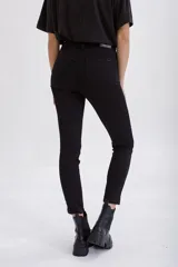 Pantalón de jean negro ajustado al cuerpo, de tiro alto y corte skinny.