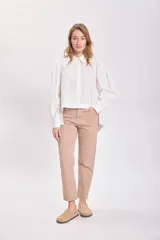 Camisa blanca de mangas largas con hombreras y cuello clásico.