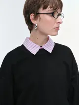 Buzo oversize de corte amplio y relajado, color rojo, con cuello redondo acanalado, mangas anchas y bajo regulable mediante elásticos.