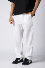 Pantalón de corte recto y holgado, confeccionado en una mezcla de lino y algodón. Presenta cintura elastizada con cordón de ajuste y bolsillos laterales amplios.