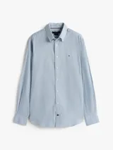 Camisa de manga larga Tommy Hilfiger con estampado Tattersal en tonos celeste y blanco. Confeccionada en tejido Oxford de algodón regenerativo, con cuello abotonado, cierre con botones y logo bordado en el pecho.