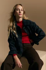 Tapado corto de lana con diseño a cuadros en tonos azul y negro, cuello camisero y cierre frontal con botones.