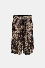 Falda de tiro alto con estampado floral en tonos beige, negro y rosado. Presenta detalles de hilo metalizado vertical y bajo asimétrico con volantes.