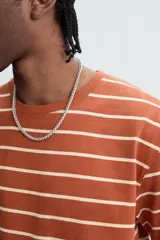 Remera color arena de corte recto, cuello redondo y mangas cortas.