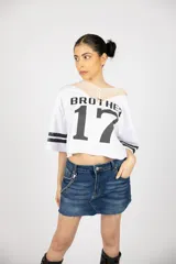 Minifalda de jean azul con lavado oscuro, tiro bajo y cadena metálica decorativa.