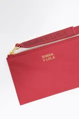 Monedero compacto de nylon negro con cierre de cremallera metálica dorada y tirador de tejido. Presenta el logo de la marca estampado en letras doradas en el frente.