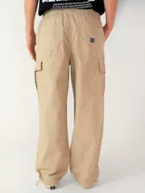 Pantalon cargo de sarga con corte loose fit, color beige, con bolsillos laterales tipo cargo y cintura elástica con cordón ajustable.