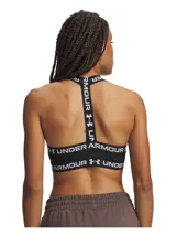 Top deportivo Under Armour modelo HeatGear Mid T Back, color negro con tirantes elásticos y banda inferior elástica con el nombre y logotipo de la marca en blanco. Cuenta con soporte estratégico y diseño de espalda en T.