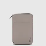Organizador de pasaporte color gris, con cierre perimetral, bolsillo externo de acceso rápido y logo grabado en la parte inferior. Incluye compartimentos internos para documentos, tarjetas y lápiz, además de un gancho para colgar.