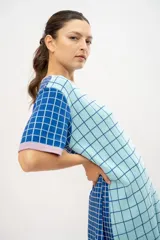 Vestido tipo remerón tejido en algodón con diseño a cuadros en tonos celeste, azul y lila.