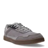 Championes urbanos Caterpillar modelo Pause Retro Leather, color gris con detalles en cuero y gamuza. Presentan suela de goma color marrón con textura hexagonal y cierre mediante cordones.