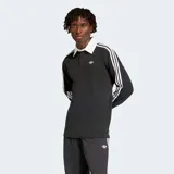 Camiseta de manga larga estilo rugby Adidas Originals, color negro con cuello polo blanco y las icónicas tres rayas blancas en las mangas. Presenta el logo del trébol bordado en el pecho y un corte holgado.