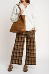 Sweater de punto en color gris melange, con diseño oversize, cuello polo y cierre frontal parcial. Presenta mangas largas y una textura acanalada suave.