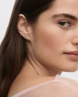 Aros pequeños dorados con forma de esfera.