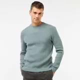 Sweater de punto con textura gofrada, cuello redondo y mangas largas con puños acanalados.