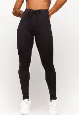 Calza negra de poliamida y elastano, con cintura alta y elástico interno.