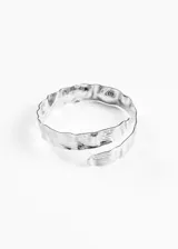 Brazalete plateado ajustable para el brazo, con diseño martillado y entrelazado.